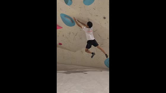 Climber takes tumble after missing hold on indoor bouldering wall in Guangdong, China