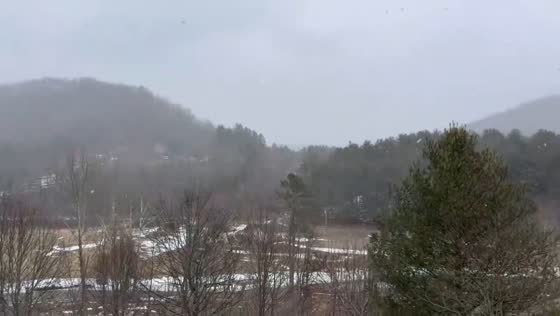 Snowfall begins to cover mountains and trees in Valle Crucis, North Carolina, USA