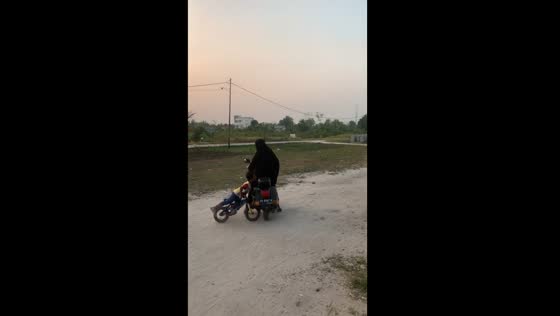 Child bumps into lady on motorbike in Palangkaraya city, Indonesia