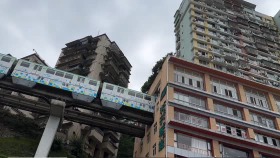 Chongqing's unusual metro: train passing through 19-floor apartment building