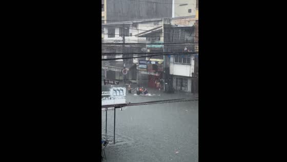 Manila residents exercise and swim in floodwaters amid typhoon Gaemi