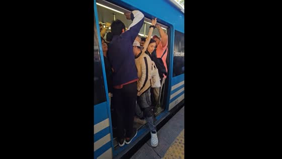 Buenos Aires rush hour: packed train makes door closing a struggle 