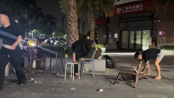 Man falls and breaks plastic chair during playful moment in Guangdong, China
