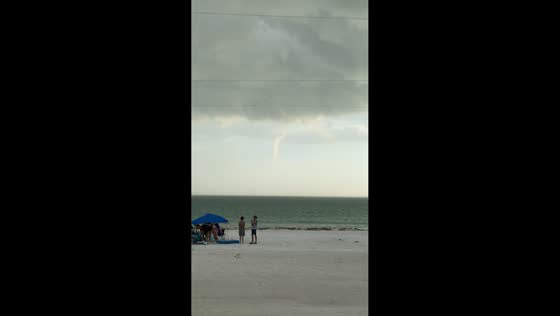 Waterspout spotted offshore near beach restaurant in Holmes Beach, Florida, USA