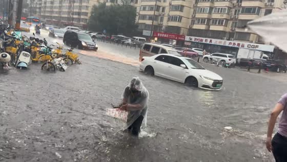 Torrential rain leaves Beijing avenue submerged in floodwater, China