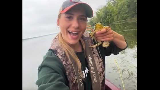 Person takes selfie with frog before releasing it in Manitoba