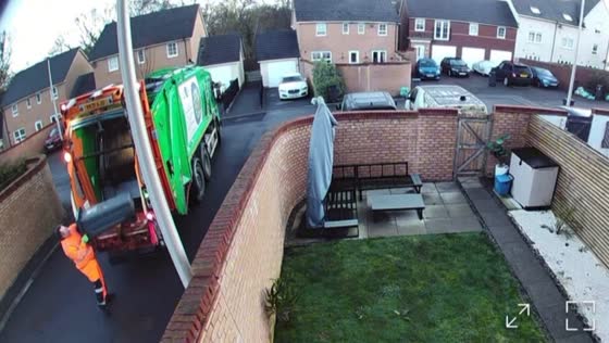 Garbage collector throws bin into truck after mishap in Cardiff, Wales, UK