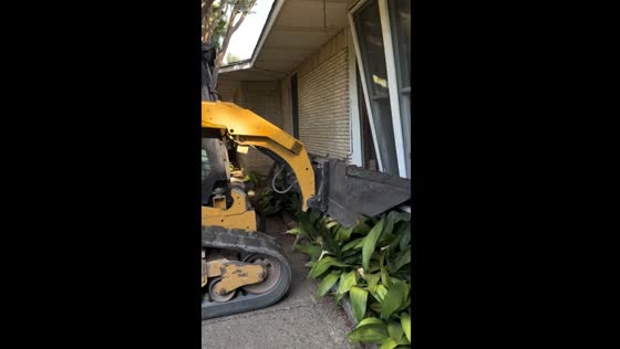 Tractor loader hits window during landscaping job in Dallas