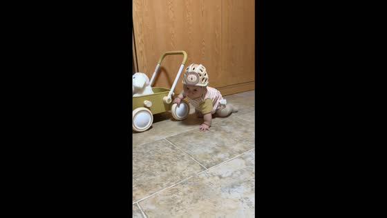Baby loses balance while holding a toy wagon in Sichuan, China