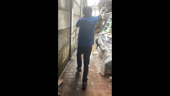 Worker catches lizard with rope during shift in Pasuruan, Java, Indonesia