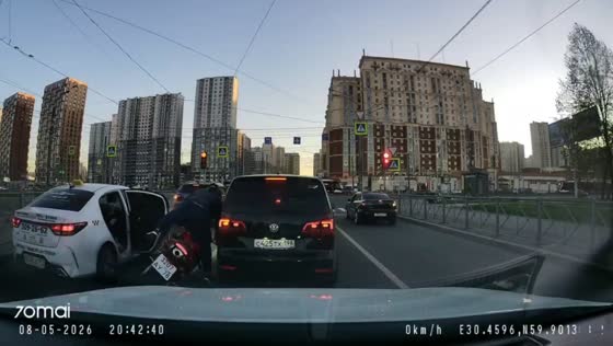 Motorcyclist crashes after taxi passenger opens door in St. Petersburg, Russia