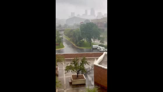 Heavy rain blurs city view during storm in Minneapolis, Minnesota