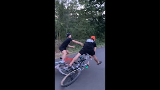 Two cyclists fall after riding in sync in Jakarta, Indonesia