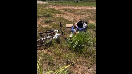 Cyclist loses control and falls into roadside bushes in Brazil