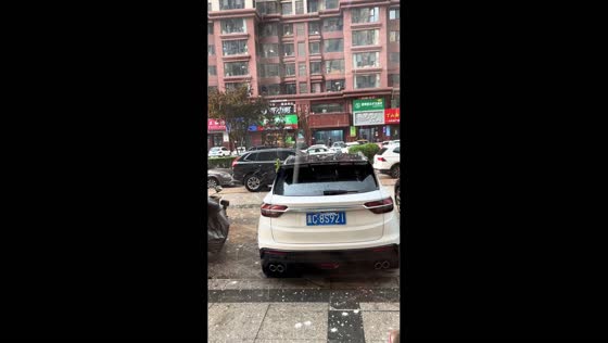Hailstorm hits parked vehicles during strong winds in Hebei, China