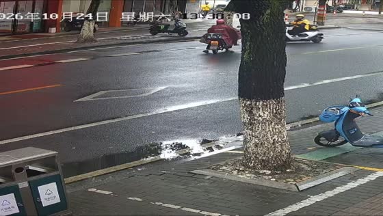 Two motorcyclists collide on wet road after one rider loses control in Zhejiang, China