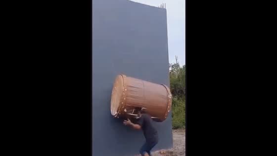 Close call: man narrowly avoids injury in drum-lifting mishap