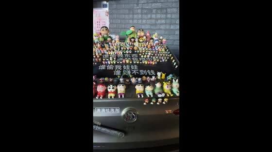 Collection of adorable character figurines displayed on a car in Jilin, China