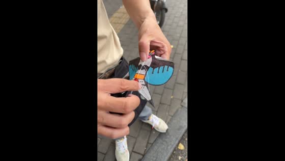 Man demonstrates flying a mini handmade kite in Beijing, China