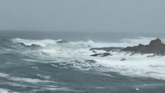 Rough surf crashes against rocky shore in California, USA