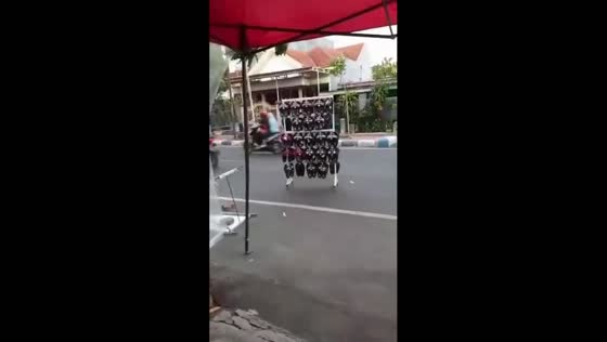 Strong winds send shoe rack rolling on roadside in Mojokerto, Indonesia