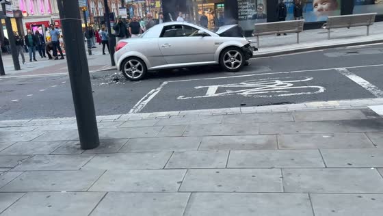 Damaged convertible drives away after collision in Leeds, UK