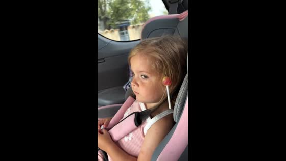 Girl rides with lollipop stuck in her hair in Blagoveshchensk, Russia