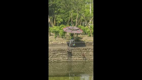Robot appears to catch fish while sitting by river in Chengdu, Sichuan, China