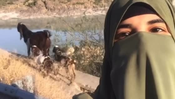 Woman talks to goats in Khairabad, they bleat in response