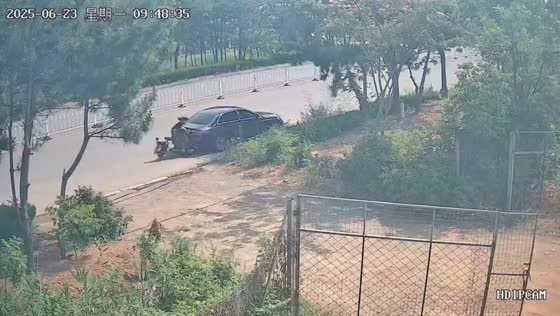 Woman on electric bike crashes into parked car in Shandong, China