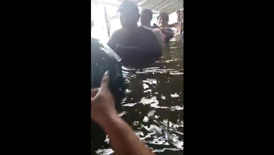 Evacuation in chest-high waters in Taliptip as typhoon Gaemi floods the Philippines