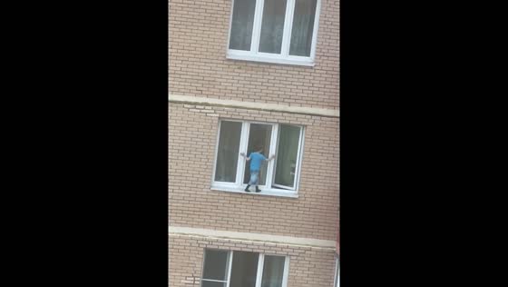Child balances on 11th floor window sill in Balashikha