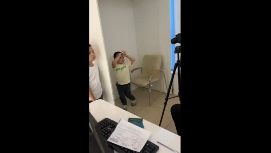 Child poses funnily for passport photo in Almaty, Kazakhstan