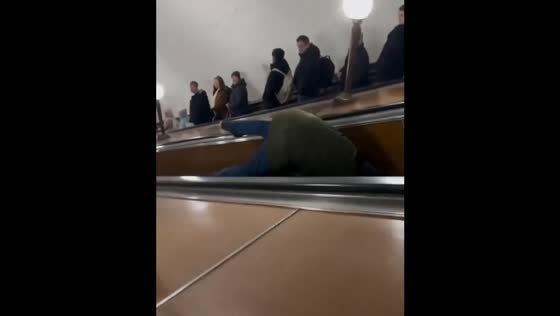 Man falls on escalator after greeting acquaintances in St. Petersburg, Russia