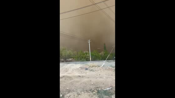 Man removes roadside fence as dust storm sweeps through Xinjiang, China
