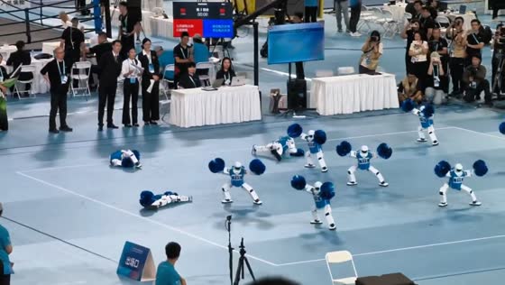Humanoid robots tumble during cheerleading routine at World Robot Games in Beijing, China