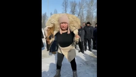 A Tuvan woman wins first place in a ram lifting contest with 60 squats on shoulders