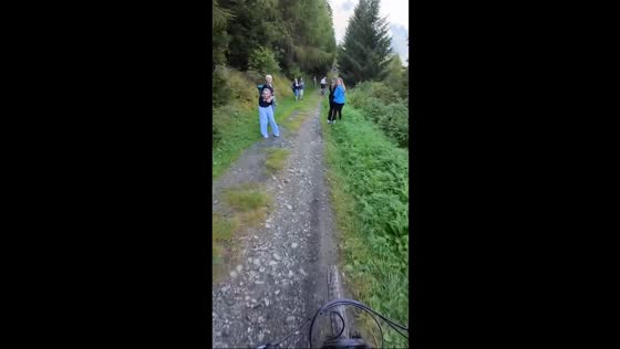 Hiker gets startled by mountain biker on 3-Country Enduro Trail in Nauders, Austria