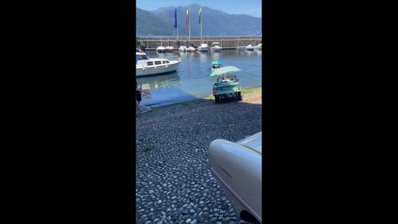 Several Amphicars sail into lake after street drive in Luino, Italy