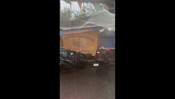 Strong winds disrupt a shop during heavy rain in Semarang, Indonesia