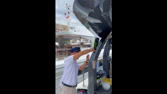 Cheerful bartender in Monte Carlo appears to make cup float