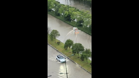 Unmanned delivery truck struggles through floodwaters during Typhoon Ragasa in Jiangsu, China