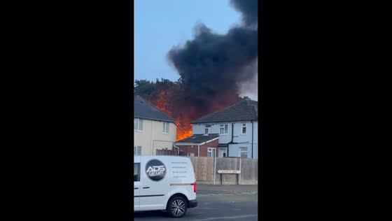 Large fire sends flames and thick smoke above homes in West Midlands, UK
