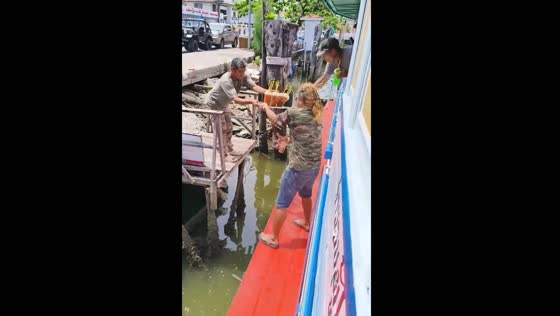 Drink spills during tray hand-off on boat
