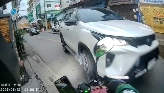 Motorcycle collides with car during turn in Bangkok, Thailand