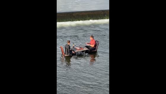 Men play chess with wine on river in Grand Rapids, USA