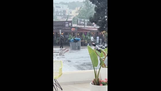 Trash bin swept away by flood waters during rainstorm in Santa Ponça, Spain