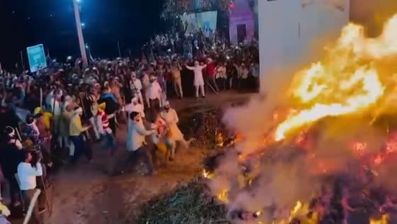 Man runs through blazing flames during traditional event in Mathura, India
