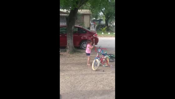 Hammer mishap startles young girl while playing with bicycle in Premont, Texas, USA