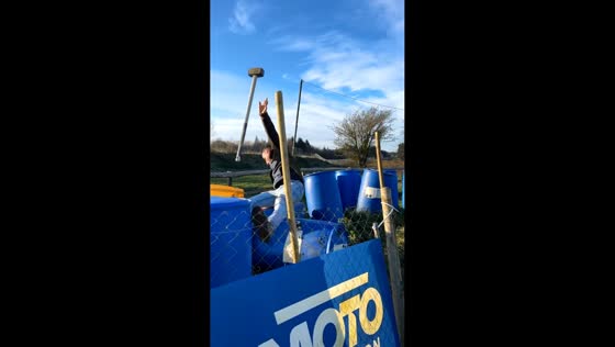 Worker slips while hammering on rolling container in Falaise, France